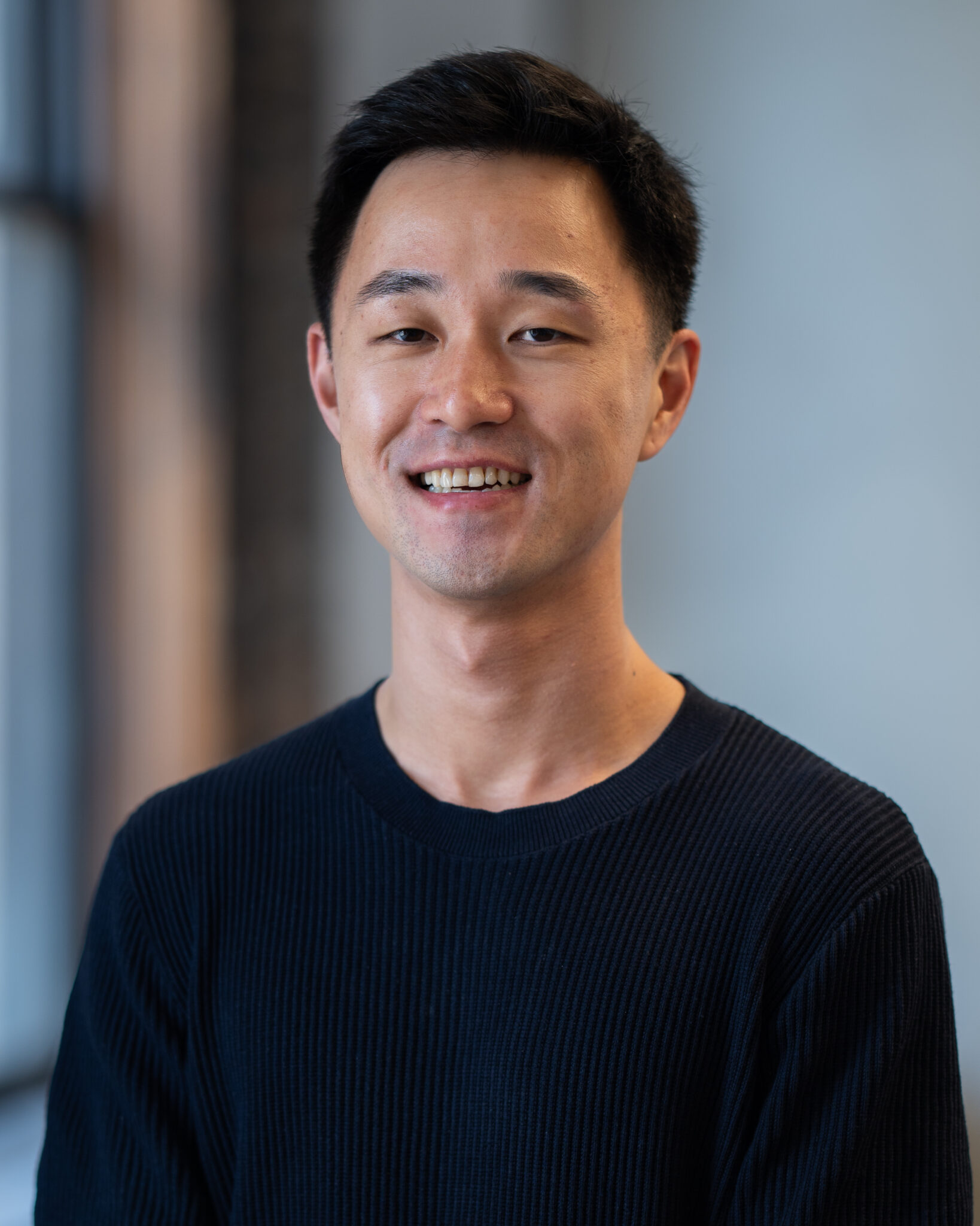 Ju Hong smiling in a professional portrait